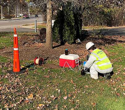 Environmental Technician Sampling a Well